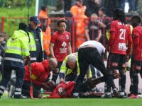 Former Arsenal star is rushed to hospital after being unconscious for ten minutes having been struck in the face with the ball during game